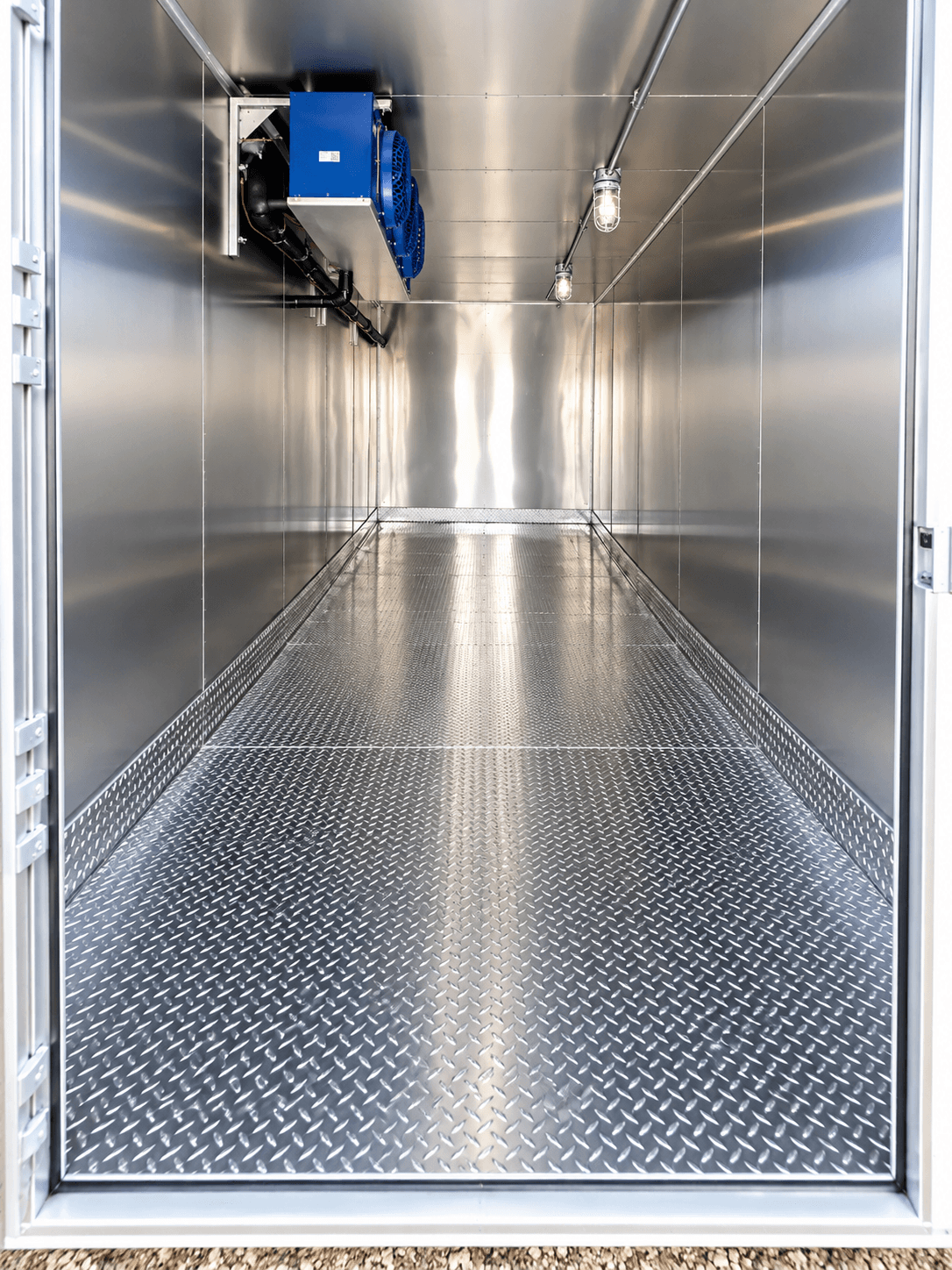 Refrigeration trailer interior with metal walls and diamond-plate flooring